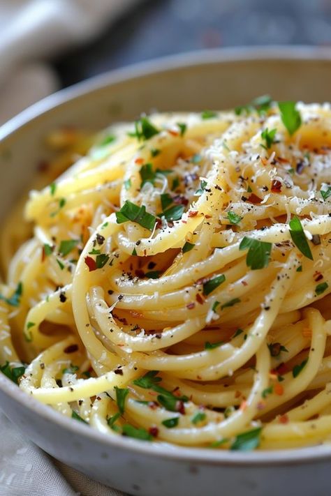 Indulge in the classic Italian flavors with our authentic spaghetti aglio e olio recipe. This simple yet flavorful dish features al dente pasta tossed in a garlic-infused olive oil sauce, finished with a sprinkle of red pepper flakes and parsley. Whether you're craving a quick weeknight meal or planning a special dinner, this recipe is sure to impress. Try making spaghetti aglio e olio at home and transport your taste buds to Italy! Spaghetti Noodles With Olive Oil, Spaghetti Pasta Recipes Noodles, Pasta With Oil And Garlic Aglio Olio, Olive Oil Butter Sauce For Pasta, Spaghetti Olive Oil Garlic, Authentic Aglio E Olio Recipes, Pasta Garlic Olive Oil, Spaghetti With Olive Oil And Garlic, Olive Oil Based Pasta Sauce