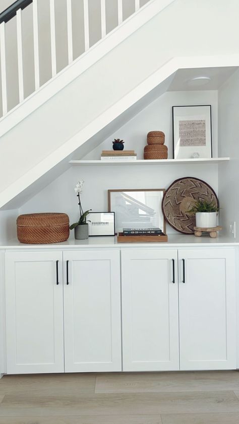 built-in storage under stairs Before & after photos of my client's home remodel in foothill ranch, ca. This portions shows the entryway, living room, kitchen, and powder bathroom. #onlineinteriordesign #interiordesign #californiacasual #homeremodel #homerenovation Upstairs Hallway Built Ins, Cottage Under Stairs Storage, Under Stair Built In Storage, Basement Storage Ideas Under Stairs, Built In Stair Storage, Modern Under Stairs Storage, Under Stair Shelving Ideas, Built In Storage Under Stairs, Under Stairs Storage Living Room