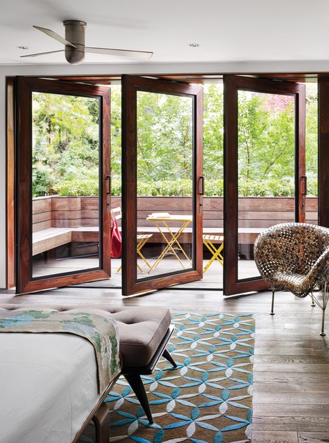 In Tia Cibani's master suite, the architect created a sizable terrace. The wood floors within the room run right out of doors, establishing a subtle sense of continuity. Thus, says Dubbeldam, “the balcony becomes part of the bedroom.” The coin chair is by Johnny Swing. The bed is from Design Within Reach. Balcony Door Design, Bedroom Balcony Ideas, Rustic Table And Chairs, Bedroom With Balcony, Pergola Shade Cover, Balcony Doors, Bedroom Balcony, Wide Plank Flooring, Sliding Glass Doors