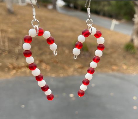 "These will be great for the Christmas holiday! Cute sea glass Christmas candy canes. Perfect little gift for someone or a stocking stuffer. Fantastic earrings for the holiday! These are 2\"  long. Earring hooks are .925 sterling silver. These will be wrapped in tissue paper, put in a box and mailed First Class in a bubble mailer. Please note: If you are outside of the US, shipping can take up to 3-6 weeks to get to you... maybe a little longer, especially during the holidays.  Be sure to check out all of my other designs and colors, using this link: https://www.etsy.com/shop/SmithNJewels?ref=seller-platform-mcnav§ion_id=27417665" Sea Glass Candy, Diy Christmas Earrings, Xmas Beads, Candy Cane Earrings, Sea Glass Christmas, Christmas Candy Canes, Beaded Jewelry Earrings, Cheap Christmas Gifts, Long Earring