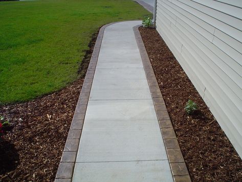 Pavers With Brick Border, Concrete Porch With Brick Border, Concrete With Paver Border, Concrete Walkway Around House, Concrete Patio With Paver Border, Concrete Pathway Ideas, Diy Walkway, Front Walkway Landscaping, Stamped Concrete Walkway