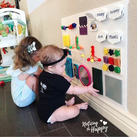 Dollar Store Busy Board – Noticing the Happy Infant Activity Board, Infant Busy Board Diy, Busy Board For 1 Year, Homemade Busy Board, Montessori Busy Board Diy, Diy Busy Board, Toddler Activity Board, Busy Board Baby, Sensory Wall