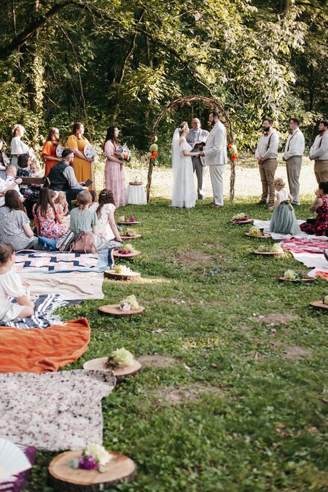 Outdoor Wedding with blanket and wooden chair seating for guests. Wooden slabs for bridal party entrance. 
Wedding arch made out of sticks. Colorful summer wedding. Bridesmaids alternatives, bouquet Bridesmaids holding wicker fan. Groomsmen in suspenders. Rainbow colors for wedding. Wedding Seat Ideas Outdoor, Picnic Blanket Wedding Seating, Picnic Style Wedding Ceremony, Picnic Ceremony Wedding, Picnic Blanket Wedding Ceremony, Outdoor Picnic Wedding Ideas, Wedding Picnic Blankets, Floor Seating Wedding Ceremony, Blanket Seating Wedding