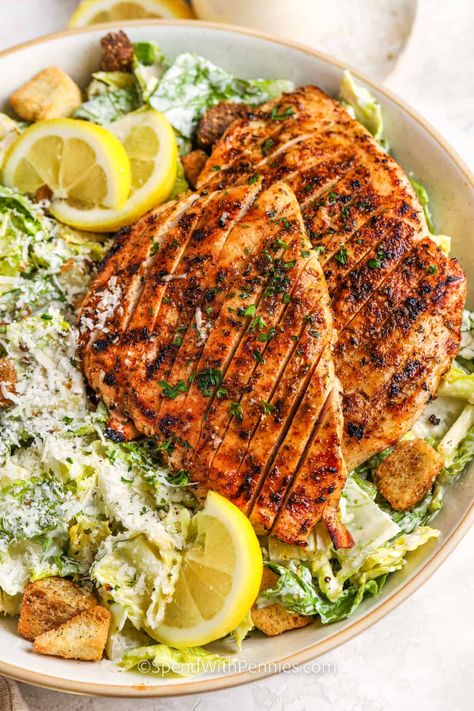 Summer wouldn't be the same without a grilled chicken Caesar salad on the menu. Make a salad at home that is better than one served at Mcdonald’s, Applebees, Wendy's, and even Paneras. This classic recipe has all the simple ingredients to make it a success - a creamy dressing, crispy croutons, and green romaine lettuce. #grilledchickencaesarsalad #chickencaesarsalad #caesarsaladwithchicken #spendwithpennies Chicken Ceaser Salad Recipe, Healthy Caesar Salad, Grilled Chicken Caesar, Salad At Home, Chicken Caesar Salad Recipe, Make A Salad, Grilled Chicken Caesar Salad, Food Pic, Easy Grilled Chicken