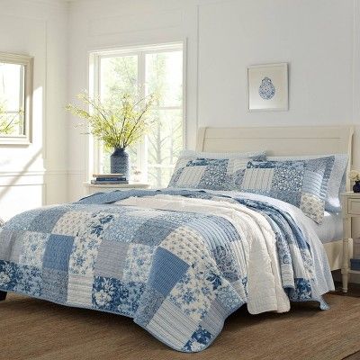 The patchwork features a combination of floral, stripes and paisley print for an overall modern take on a traditional design. The quilt reverses to a vertical white stripe on a blue ground that also binds the quilt. Prewashed for extra softness, the cotton quilt features a polyester fill. Included shams feature an overlap closure. Twin Quilt Set includes: One twin quilt (88"L x 68"W) and one standard sham (21"L x 27"W), Full/Queen Quilt Set includes: One full/queen (90"L x 90"W) and two ... Laura Ashley Bedding, Paisley Quilt, King Quilt Sets, Cotton Quilt Set, Design Apartment, Quilted Sham, Twin Quilt, Quilted Coverlet, Blue Quilts