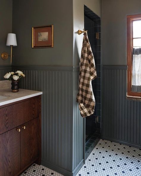 Guest Bath Wainscotting, Wainscoting Around Bathroom Vanity, Wainscoting Behind Vanity, Black And White Hall Bathroom, Half Laundry Half Bathroom, Tiled Wainscoting Bathroom, Modern French Bathroom Ideas, Dark Traditional Bathroom, Bathroom Remodel With Wainscoting