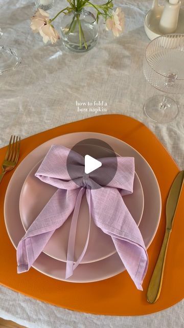 Ashley Tassano on Instagram: "I decided to add this bow napkin last minute, and I’m so happy I did. Not only was it simple, but everyone loved it! You could also make these with a napkin ring or a clear elastic instead of the ribbon.   Tip: Save the ribbon to use again or add it to glassware for your next event. ✨  #coquette #bows #napkinfolding #tablescapes #tablescapestyling #tablescapetuesday #discover" Tea Party Napkin Rings, Paper Napkin Bow, Tying Napkins With Ribbon, Now Napkin Fold, How To Fold A Napkin Into A Bow, Cute Napkin Folds Easy, Bow Napkin Wedding, Cute Ways To Fold Napkins, Bow Napkin Ring