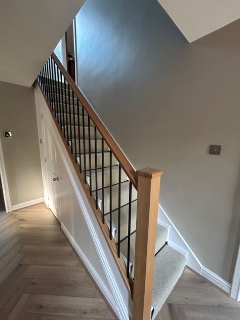 Hall makeover; Flooring from @tapicarpetsandfloors - Herringbone hard flooring and 100% wool carpet and runner along with black rods. Staircase from @nevillejohnson Oak posts, oak handrail and black metal spindles. Paint - Elephants breath from @farrowandball and eggshell brilliant white on woodwork. Accessories to be added further and internal doors to be changed to oak. All sockets and handles changed to brushed chrome. Oak Stairs Black Spindles, Oak Staircase With Metal Spindles, Oak And White Staircase With Runner, Oak Stairs Black Railing, White Staircase Black Spindles, Painted Staircases With Carpet, Oak Staircase With Carpet Runner, Oak Staircase With Carpet, Changing Stair Spindles