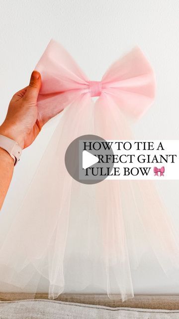 Gift Baskets Wrapped In Tulle, How To Tie A Tulle Bow, Bow With Tulle Diy, Tulle Hair Bows Diy, Pink Tulle Bow, Making A Bow With Tulle, Crafts With Tulle Diy, Diy Tulle Christmas Decorations, How To Decorate A Christmas Tree With Tulle