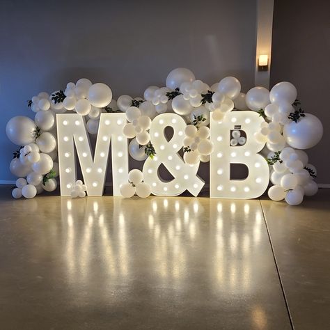 Add a personalized touch to your wedding that really makes a statement with marquee letters! Wrap with balloons to make it a showstopper! So fun for pictures Engagement Marquee Letters, Last Name Balloons Wedding, Engagement Initial Letters Decoration, Engagement Party Marquee, Big Letters Decoration Wedding Ideas, Big Letters For Wedding, Marquee Letters At Wedding, Balloon Decor For Wedding Receptions, Wedding Big Letters