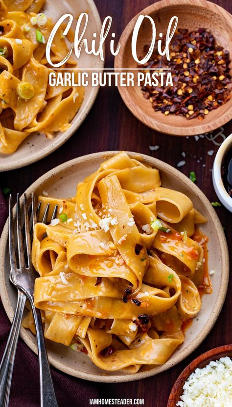 A bowl of chili oil garlic butter pasta with a fork for eating, a second bowl of pasta and garnishes like red pepper flakes and parmesan are in the background. Crunchy Garlic Chili Oil, Homemade Chili Oil, Garlic Chili Oil, Garlic Butter Noodles, Crunchy Garlic, Garlic Noodles Recipe, Garlic Butter Pasta, Chili Oil Recipe, Butter Pasta