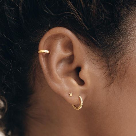 No piercing? No problem! Our Ear Cuff lets you accessorize without the commitment of piercings. And it looks awesome when paired with other hoops and studs! Sold as a single piece. How to wear it: slide the cuff on to your ear the thinnest part (usually toward the top), and then slide it down until it sits snugly. Five Piercings Ears, Stud And Hoop Ear Piercing, Ear Earrings Piercings, Ear Style Ideas, Piecing Ideas Ear, Ear Piercings Women, Ear Piercing Women, Gold Ear Piercings, Single Ear Piercing