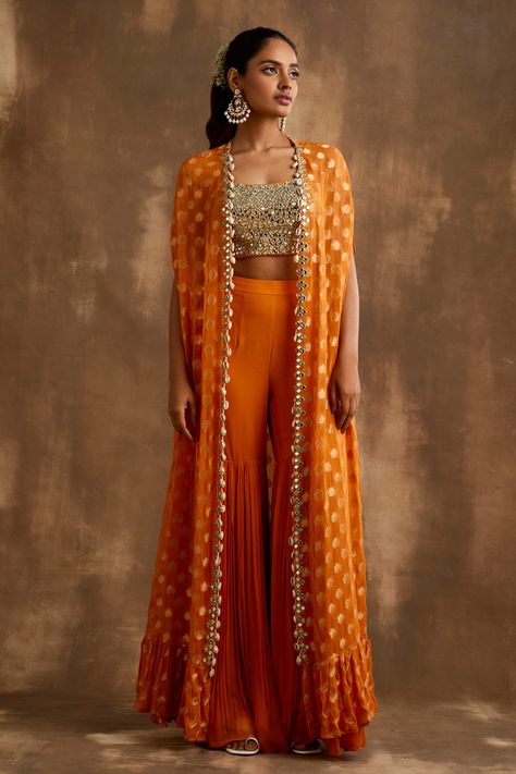 Shop for these amazing collections of Orange Georgette Embroidered Mirrorwork Floral Pattern Gharara Set For Women by Niamh By Kriti online at Aza Fashions. Orange Indian Lehenga, Orange Indo Western Outfits, Cape Indian Outfit, Indian Cape Outfits, Orange Traditional Outfits, Indo Western Sangeet Outfit For Women, Haldi Indowestern Outfit, Orange Haldi Outfit, Indian Haldi Outfit