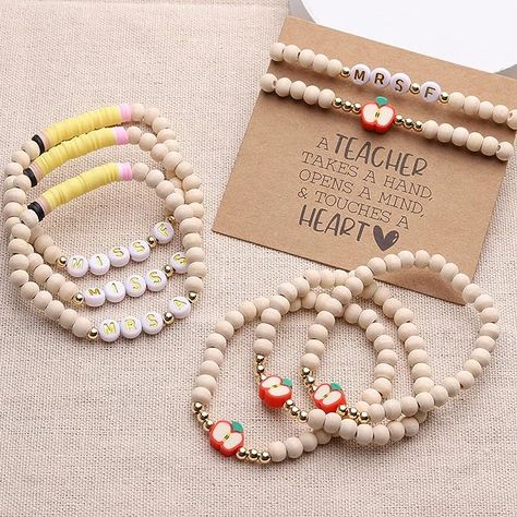 This is a personalized bracelet for a teacher or caregiver. The personalized beads are white with gold color writing. The rest of the bracelet is a cream color wood bead. Teacher Bracelet, Teacher Jewelry, Appreciation Gifts Diy, Teacher Appreciation Gifts Diy, Clay Bead Necklace, Teachers Diy, New Teacher, Wood Bead Bracelet, Gifts Teacher