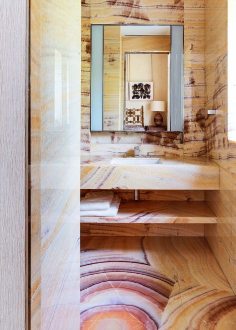 In the guest bath the floors wall and vanity are made of Onyx Arco Iris. The sink fittings and mirrored medicine cabinet... Peter Marino Interior, Lighted Medicine Cabinet, Прикроватные Тумбочки, Geometric Lighting, Bathroom Design Inspiration, Dream Bathrooms, Deco Furniture, Contemporary Luxury, Architectural Digest