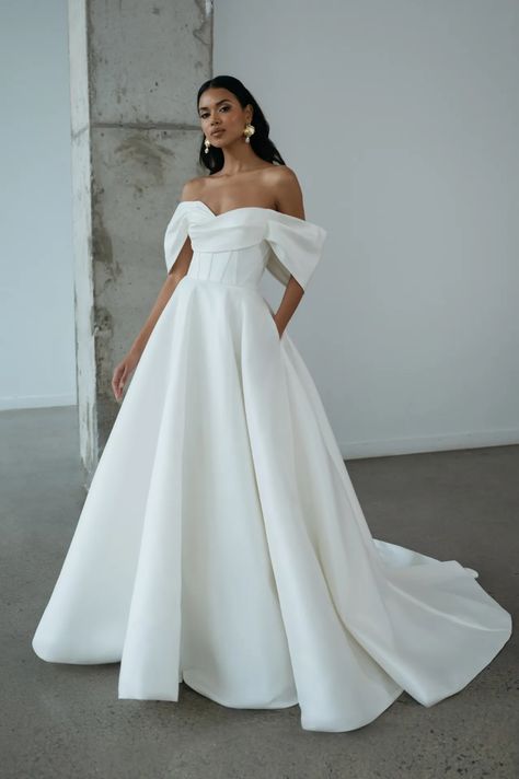 Jenny Yoo Bridal Spring 2025 Collection [PHOTOS] Satin Wedding Gowns With Sleeves, Wedding Dresses Off The Shoulder Satin, Sheri Hill Wedding Dresses, Stassi Wedding Dress, Ethereal Wedding Dress Satin, Off Shoulder Wedding Dress Classic, Wedding Gown Off The Shoulder, Wedding Dresses All White, Long Sleeve Cowl Neck Wedding Dress