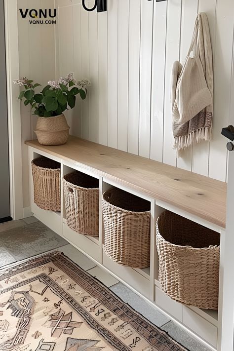 Maximize your entryway's functionality and style with this organized storage solution. Featuring a sleek wooden bench with built-in cubbies, perfect for storing baskets to keep your space clutter-free. The addition of a potted plant and a cozy hanging scarf adds a touch of warmth and personality. Ideal for busy households looking to keep their entryway tidy and inviting. Explore more tips and ideas to create a practical and stylish entry. #EntrywayDesign #HomeOrganization #EntrywayDecor #Functio Storage Bench Entryway Decor, Console Table Hallway With Shoe Storage, Entry Bench And Shoe Storage, No Entry Entryway, Entryway Seating And Storage, Entryway Built In Bench Ideas, Built In Entry Bench With Storage, Foyer Organization Ideas, Diy Wooden Storage Bench