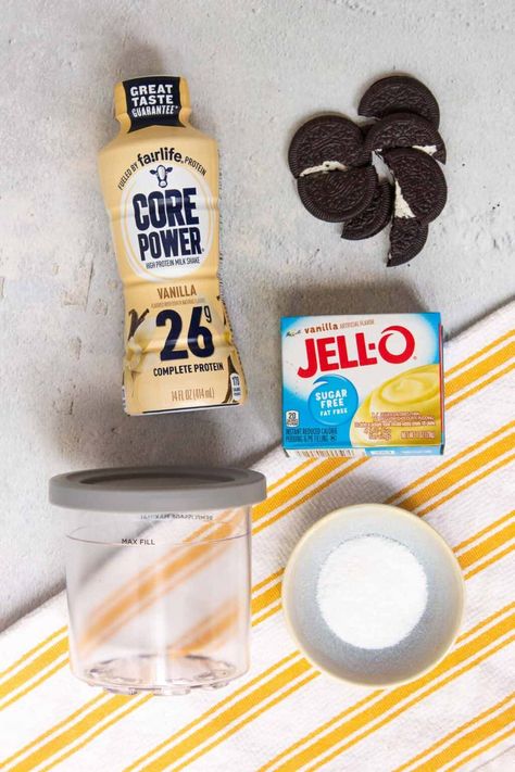 This Ninja Creami Oreo protein ice cream recipe is made with a vanilla Fairlife Core Power High Protein Milkshake, stevia, instant pudding mix, and Oreo Thins. This high-protein homemade ice cream recipe is designed for the Ninja Creami ice cream maker and has fewer calories, less fat, less carbohydrates, and more protein than regular ice cream. You start with a simple vanilla ice cream and use the mix-in function to incorporate Oreo Thins cookies. Ninja Cremi Fairlife, Ninja Creami Protein Ice Cream Recipe Vanilla, Ninja Creami Protein Shake, Ninja Cremi Premier Protein, Fairlife Creami Recipes, Ninja Creami Ice Cream Recipes Premier Protein, Protein Shake Ice Cream Recipe, Fairlife Protein Ninja Creami Recipes, Core Power Protein Shake Recipe