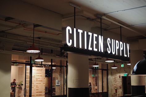 Environmental retail sign and branding for Citizen Supply neon and iron hanging sign in front of store inside Ponce City Market in Atlanta. Signage Restaurant, Lightbox Signage, Restaurant Signage, Illuminated Signage, Store Branding, Signage Board, Light Box Sign, Company Signage, Retail Signage