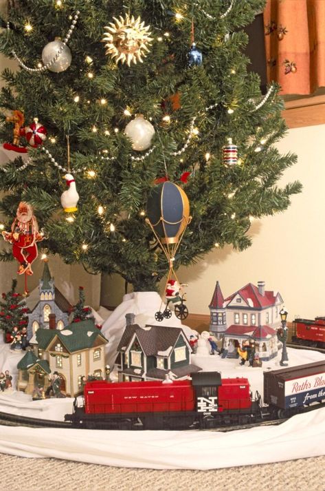 Choosing a train for the Christmas tree | News, Sports, Jobs - Lawrence Journal-World: news, information, headlines and events in Lawrence, Kansas Christmas Tree With Train And Village, Train Under Christmas Tree, Train Around Christmas Tree, Christmas Tree Train Set, Christmas Tree Train, Christmas Train Set, Christmas Tree Village, Christmas Village Sets, Christmas Layouts