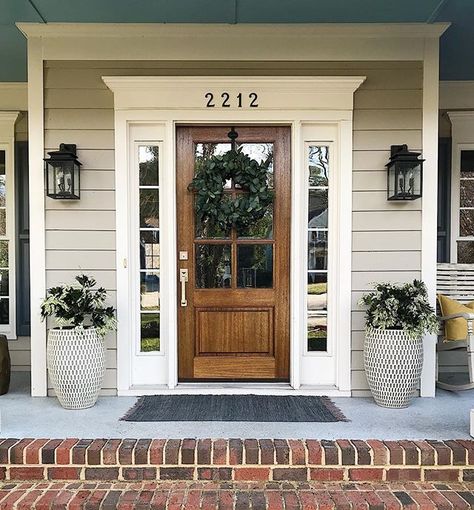 Haven’t worked on the front porch since December but when it’s March and 60 degrees...you get to it! Spring, we’re ready for you! Front Door With Lanterns, Front Door Tudor Home, Decorate With Shutters Inside, Front Door With Shutters On Each Side, Wood Front Door Brick House, Farmhouse Style Front Door, Front Door For Brown House, Front Door Farmhouse Entrance, Front Door Ideas Wood