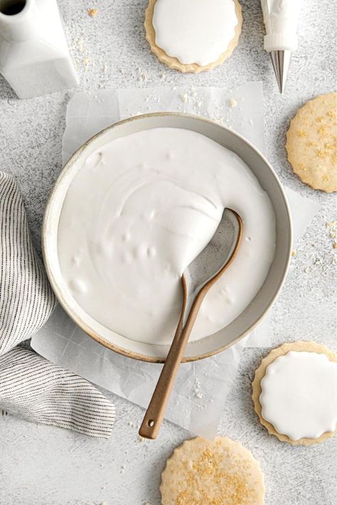 Homemade royal icing in a bowl with spoon next to frosted shortbread cookies and a piping bag fitted with a metal tip. Royal Icing Recipe For Gingerbread House, Royal Icing For Cookies, Icing For Cookies, Cream Of Tartar Recipe, Icing For Gingerbread Cookies, Royal Icing Recipe With Egg Whites, Easy Royal Icing, Gingerbread House Icing, Decorating Sugar Cookies