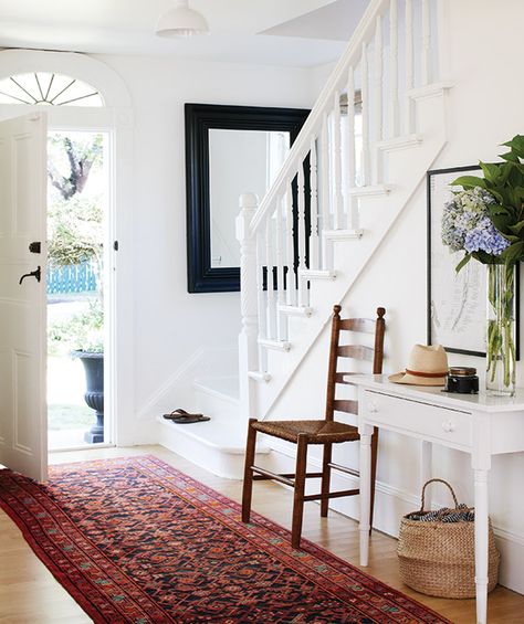 Find out why it's designer and stylist Deb Nelson's dream home. Most Popular Paint Colors, Foyer Furniture, White Staircase, Popular Paint Colors, Casas Coloniales, Entryway Console Table, Foyer Decorating, Mirror On The Wall, Entry Way Design