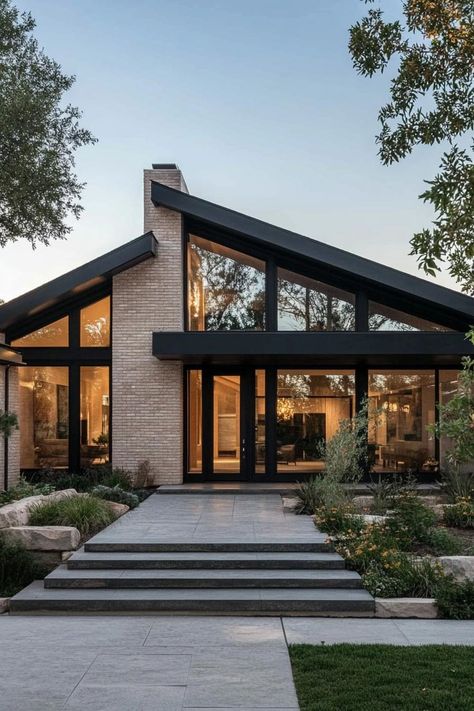 Modern ranch house facade with black framed windows and doors. Check out all of these modern ranch houses with creative and stylish designs that blend simplicity with sophistication. Exterior Of Modern House, Tom Kundig Houses, Modern House With Lots Of Windows, Skillion Roof House Design, Modern Home Front Porch, 70s House Renovation Exterior, Modern House Addition, Prairie House Exterior, 2500 Sq Ft Modern House Plans