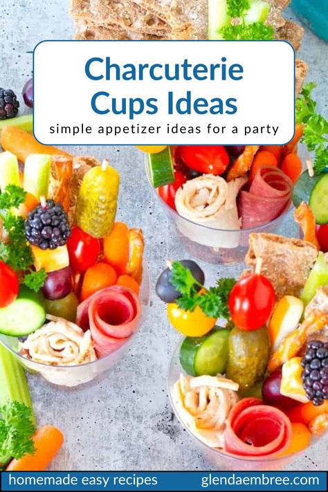 Various charcuterie—rolled slices of deli meat, skewers of cheese cubes and fruit chunks, nuts, pretzel sticks and fresh veggie sticks in  clear plastic cups for individual appetizer portions. Snack Cup Ideas Parties Food, Charcuterie Cups Recipes, Teacup Charcuterie, Charcuterie Cups Baby Shower Ideas, Charcuterie Cup Ideas Easy, Snack Cups For Party, Individual Cup Appetizers, Make Ahead Charcuterie Cups, Charcuterie Party Cups