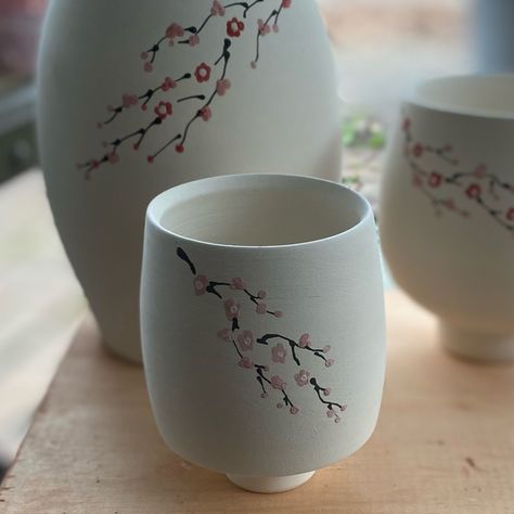 Cherry blossom yunomi . . . . #cherryblossom #porcelain #ceramics #handpainted #ceramicsofinstagram #wheelthrownceramics Cherry Blossom Mug Painting, Ceramic Glass Design, Painting Ideas On Clay, Pottery Painting Japanese, Japanese Pottery Painting, Painting On Ceramics Ideas, Cherry Blossom Pottery, Painted Mug Ideas, Clay Painting Ideas