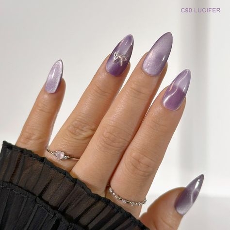 C90 Lucifer - Treat your nails like royalty with this luxurious shade of silky lilac purple. The Coquette Silk Cat Eye Collection comes with soft and dreamy neutral colors made with ultra fine magnetic particles that give these gel polishes that extra brilliance. Wear these gorgeous silky cat eye gels by themselves or layer it over other base colors and let your nails shine! Charme Gel Polish is a 3-step gel system that offers a highly pigmented, long lasting formula. It is gentle on natural nai Elegant Nails Cat Eye, Cat Eye Nails For Wedding, Purple Shade Nails, Magnetic Purple Nails, Classy Nails Purple, Natural Cat Eye Nails, Cat’s Eye Nails, Lilac Cat Eye Nails, Purple Nail Art Simple