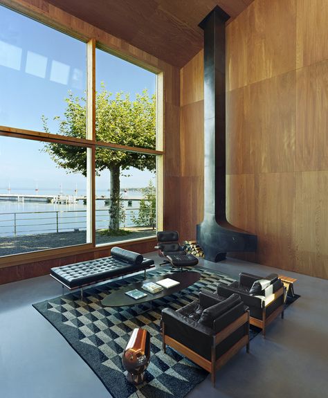 The 6,780-square-foot interior is completely lined in larch, a wood grown in the surrounding Alps and selected to give the feeling of an Alpine home. The metal fireplace was bought off-the-shelf from the French fireplace company Focus. ‘The model is from the ‘70s, made for a French ski resort,’ Mr. Dentand says. Barcelona Couch, Eames Coffee Table, Eames Table, Leather Daybed, Interior Minimalista, Lake Geneva, Interior Design Magazine, New York Apartment, Steel House