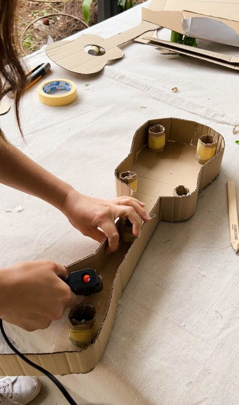 A Pair & A Spare | Making a Kids Cardboard Guitar Guitar Box Diy, How To Make Guitar With Cardboard, How To Make A Guitar Out Of Cardboard, Cardboard Guitar Diy, Kids Guitar Craft, Guitar Art Diy, Dramatic Play Diy, Guitar Craft, Cardboard Guitar