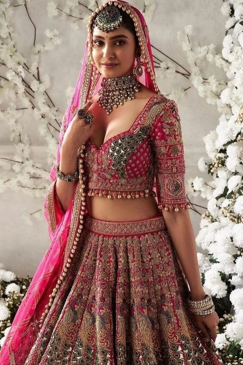 Planning to wear a pink bridal lehenga at your wedding? Here are 50+ bridal lehengas in all shades of pink to inspire you. Light Weight Bridal Lehenga, Indian Wedding Outfits Bridal Lehenga Red And Pink, Bridal Lehenga Designs Latest Pink, Bridal Lehenga Inspiration, Bridal Lehenga Latest Designs, Reception Blouse Design For Bride Pink, Bridal Lehenga For Wedding, Indian Wedding Lehenga Bridal Pink, Wedding Lehengas Bridal Pink