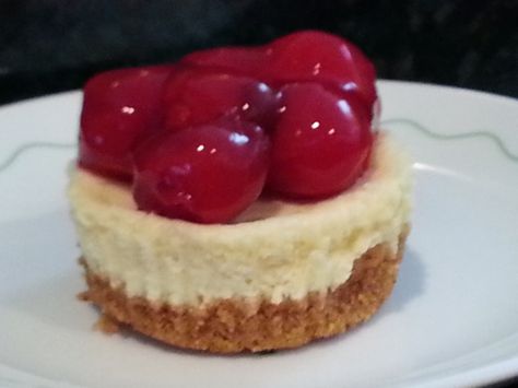 These are festive little cakes After cooled garnish with a sprinkle of cake sprinkles or get creative and use fresh berries; fresh sliced fruits; toasted coconut..... Prep time unknown; baking time 20 minutes THE BORDENS EAGLE BRAND CONDENSED MILK PROVIDES THE SWEETNESS TO THE CHEESECAKE MIXTURE...SUGAR IS NOT NEEDED. (except for stated amount in crust.) Miniature Cheesecakes, Mini Cherry Cheesecakes, Cherry Cheesecake Recipe, Mini Cheesecake Bites, Cheesecake Desserts Recipes, Mini Cheesecake Recipes, Cheese Tarts, Cheesecake Cupcakes, Cherry Cheesecake