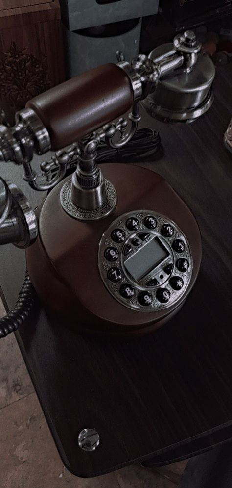 its an old vintage style phone, giving 80's aesthetics vibe, in a dark academia style Old Phone Aesthetic Dark, Vintage Business Aesthetic, Dark 1950s Aesthetic, Gramaphone Wallpapers, Old Phone Aesthetic Vintage, Vintage 1930s Aesthetic, Gramophone Aesthetic, Dark Academia Character Design, Old Phone Aesthetic