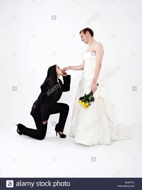 Bride wearing a suit kissing the hand of a groom wearing a wedding dress, exchange of wedding clothing, Austria Female Wedding Suit, Corpse Bride Dress, Wedding Meme, Kissing Poses, Worst Wedding Dress, Bride Suit, Clothes Swap, Asian Style Dress, Woman In Suit