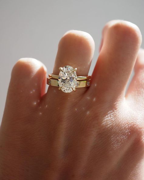 Kate & Kole | The perfect pairing — Our Clara 3.09ct Oval Solitaire Engagement Ring paired perfectly alongside our newest addition to our Wedding Band… | Instagram Thick Gold Wedding Band, Gold Oval Engagement Ring, Thick Wedding Bands, Gold Band Engagement Rings, Thick Gold Band, Oval Solitaire Engagement Ring, Stacked Wedding Bands, Celestial Ring, Future Engagement Rings