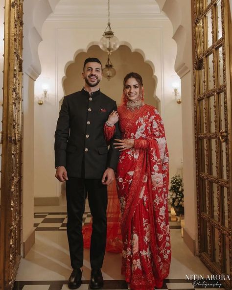 This couple nailed the reception look like a pro ♥️ Swipe to see the stunning wedding reception photos and don't miss to see the last picture😍❤ Gorgeous Bride: @jaislinchona Handsome Groom : @gurrajsingh037 MUA: @makeupbysahibachona Hair: @hairbydablu Saree: @taruntahiliani Jewelry: @sunita_shekhawat_jaipur Photographer: @nitinaroraphotography Event Planner: @rudraevent Decor: @weddinglightsevents #redsaree #reception #weddingreception #indianweddingreception #receptionbride #sare... Indian Groom Bride Outfit, Bride In Saree And Groom In Suit, Wedding Reception Look Indian Bride, Indian Reception Outfit Groom, Indian Wedding Outfits Bride And Groom, Reception Dress Indian Couple, Reception Outfit For Groom Indian, Reception Look Groom, Bride Reception Saree Look