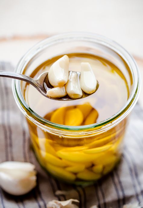 How to Make Garlic Confit and Homemade Garlic Oil. This delicious kitchen staple will take your dishes to the next level! #garlic #confit #abeautifulplate #howto #recipe Garlic In Olive Oil, Garlic Confit, Garlic Infused Olive Oil, Garlic Olive Oil, Garlic Oil, Infused Olive Oil, Garlic Recipes, Infused Oils, Roasted Garlic