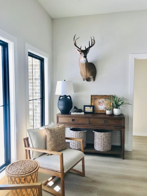 Antlers In Living Room, Deer Head Office Decor, Deer Mount In Office, Living Room With Animal Mounts, Modern Farmhouse Living Room With Deer Mounts, Living Room Wall Decor With Deer Head, Country Living Room With Deer Heads, Interior Design With Deer Heads, Deer Head Dining Room