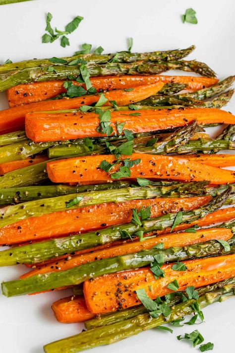 Roasting carrots and asparagus together in the oven is quick and delicious! This recipe is an easy side dish that pairs with array of dishes. Serve the vegetables with lemon wedges and grated parmesan. Roasted Carrots And Asparagus, Carrots And Asparagus, Easy Roasted Carrots, Asparagus In The Oven, Baked Asparagus, Roasted Vegetable Recipes, Cooked Carrots, Roasted Asparagus, Asparagus Recipe