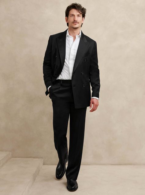 Elevate your formal attire with a sophisticated black double-breasted suit paired with a white dress shirt and sleek black Chelsea boots. A simple and flawless ensemble that blends timeless elegance with contemporary flair. Black Gala Outfit Men, High Waisted Suit Men, Black Formal Wear Men, Black Suit Men Outfit, Black And White Gala Outfit, Men Black Tie Wedding Guest Attire, Man Formal Outfit, Black Suit No Tie, Black Suit Outfit Men