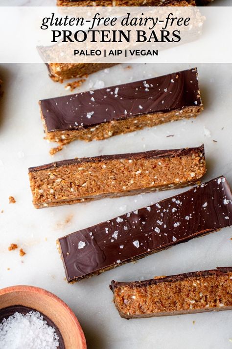 These are the Best Gluten-Free Dairy-Free Protein Bars! They’re soft and fluffy, packed with fiber and protein, and topped with a smooth chocolate coating. These homemade, no-bake paleo protein bars are vegan- and Modified AIP-friendly. They’re the perfect grab-and-go snack or wholesome treat! #proteinbars #glutenfreedairyfreerecipes #glutenfreeproteinbars #dairyfreeproteinbars #paleoproteinbars #nobakeproteinbars #soyfreeproteinbars #veganproteinbars #aipproteinbars #diyproteinbars Paleo Protein Bar, Gluten Free Protein Bars Homemade, Vegan Protein Bars Homemade, Paleo Protein Bars Homemade, Raw Protein Bars Recipe, Protein Date Bar, Quinoa Protein Bar, Aip Protein Snacks, Copycat Perfect Bar Recipe