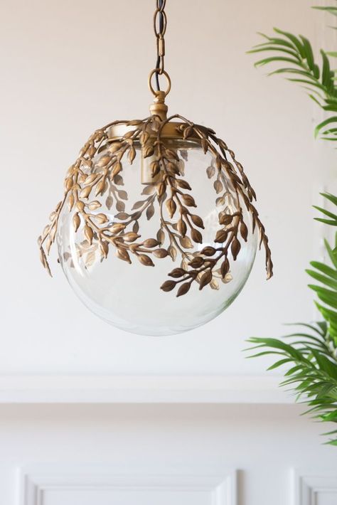 Lifestyle image of the Ornate Globe Pendant Ceiling Light With Brass Leaf Detailing with a table below Glass Pendant Shades, Glass Globe Pendant Light, Globe Ceiling Light, Rockett St George, Ceiling Light Shades, Vintage Pendant Lighting, Globe Pendant Light, Bedroom Ceiling, Brass Pendant Light