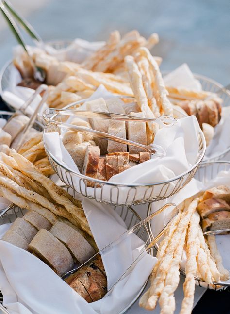 Offer bowls filled with a variety of different breads at each table so guests can pick exactly which type they want with their meal. Seasons Catering baked this spread. Bread Basket Display, Festive Bread, Cocktail Hour Food, Bread Display, Catering Food Displays, Fruit Displays, Food Stations, Bread Appetizers, Bread Serving