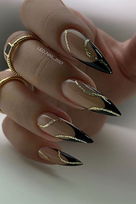 Classy stiletto black French tip nails with gold glitter swirl nail art Nails To Go With Black Outfit, French Black Nail Designs, Gorgeous Almond Nails, Black French Tip Nails Almond With Gold, Gel X Black French Tip, Gold Black French Nails, Black And Gold Tips Nails, Black Art Deco Nails, Wedding Nails Black And Gold