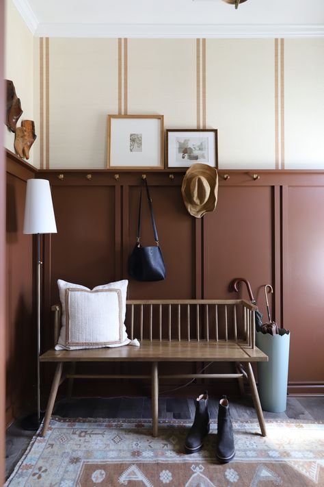 Our Dark and dreary entry got a makeover! We added wallpaper, board and batten (in a fun double stripe pattern!), moody brown paint, a DIY Peg rail, and a brand new door! Mudroom Ideas Entryway Board And Batten, Corridor Inspiration, Paint Wainscoting Ideas, Moody Front Entry, Board Batten Entryway, Stairwell Entryway, Beadboard Half Wall Mudroom, Board And Batten Wall With Pegs, Mudroom Peg Rail