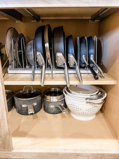 Cooking pans organized with a vertical rack from You Copia Pans Cabinet Organization, Pan And Pot Organization, Pan Kitchen Storage, Cabinet Pan Organizer, Cast Iron Organization Storage Ideas, Pot And Pan Display, Apartment Pots And Pans Storage, Lots And Pans Organization, Kitchen Cookware Organization