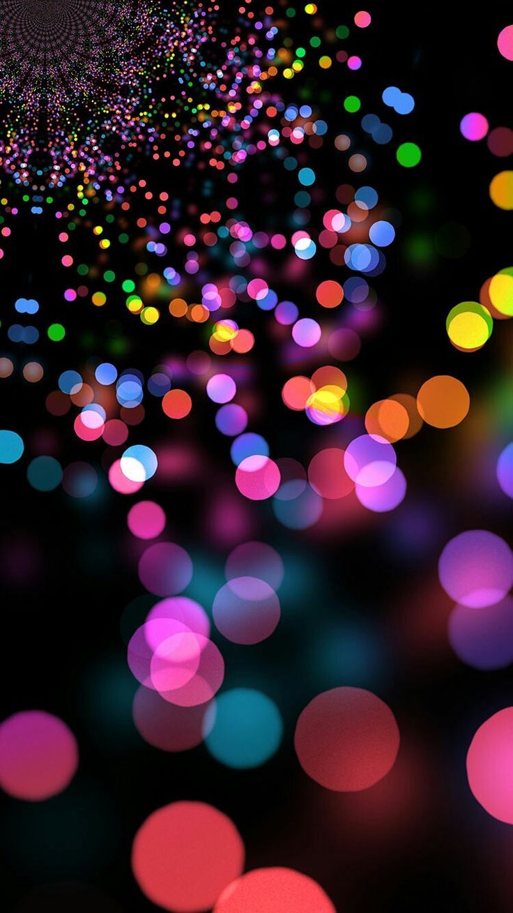 an image of colorful lights that are blurry in the dark night time, as well as stars and circles